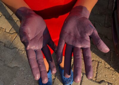 hands of a child covered with paint